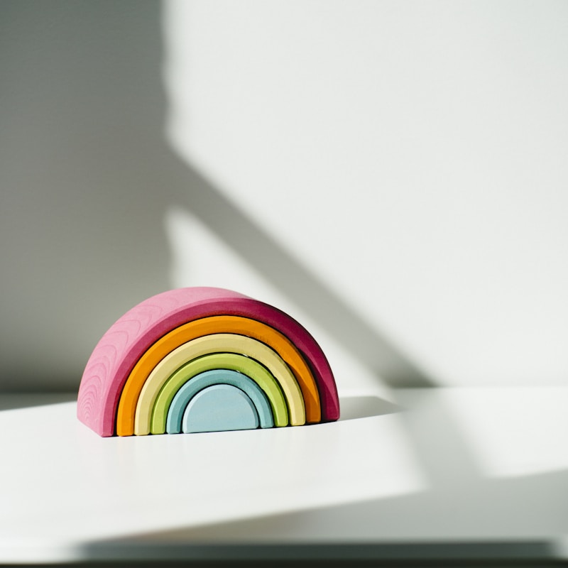 Rainbow stacking tower on cream background