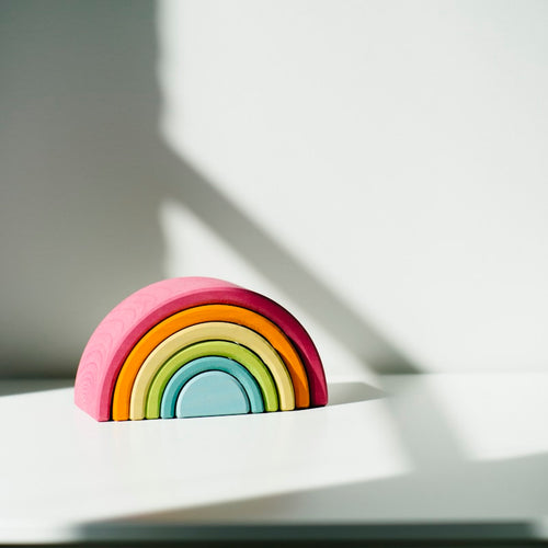 Rainbow stacking tower on cream background